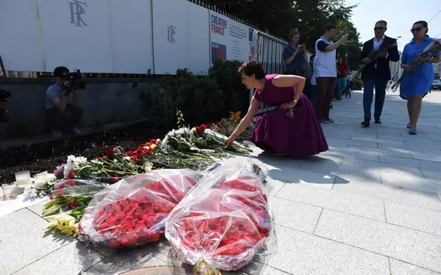 People lay flowers at the scene of the attack in Nice