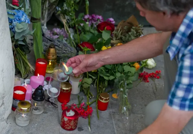 In Bratislava, Slovakia, candles and flowers have been placed outside the French embassy