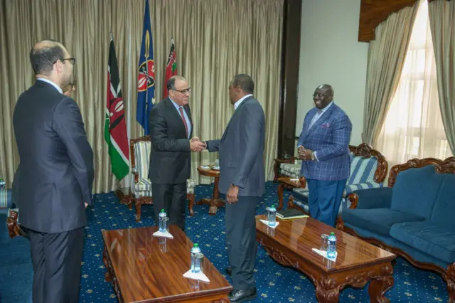 Taib Fassi Fihri shakes hands with Uhuru Kenyatta