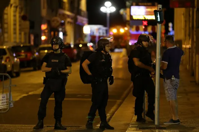 Police officers patrol and carry out checks in the centre of French Riviera town of Nice