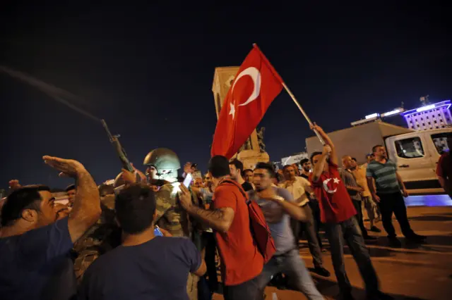 Supporters of Turkey"s President Recep Tayyip Erdogan, protest in front of soldiers in Istanbul"s Taksim square, early Saturday, July 16, 2016.