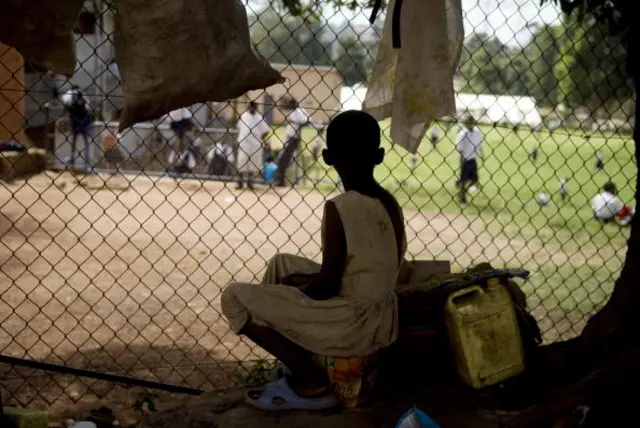 Girl sitting outside school in Kampala Uganda