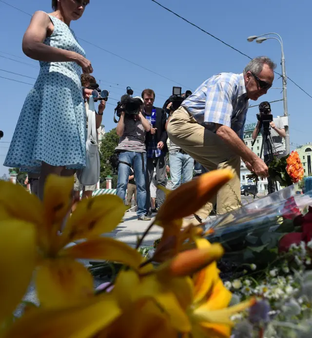 People lay flowers at the scene of the attack