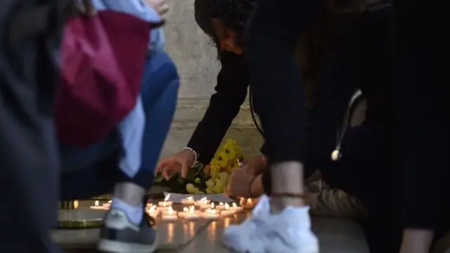 Flowers and candles have been left outside the French embassy in London