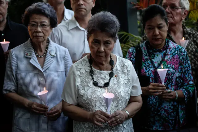 People hold candle during a vigil for the victims of the attack in the French city of Nice at the Alliance Francaise, on July 15, in Bangkok