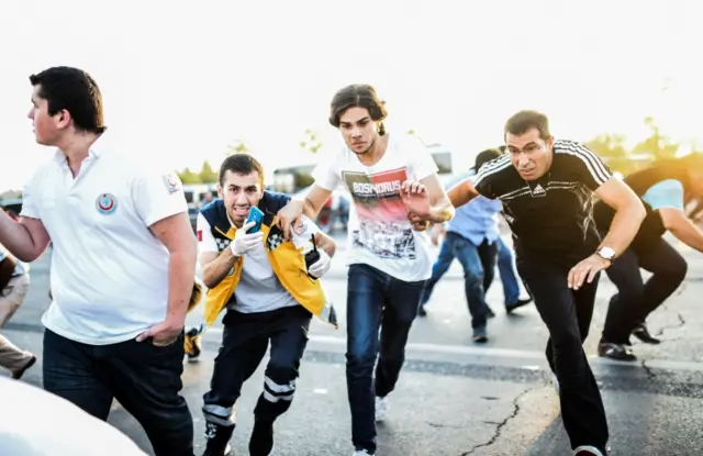 People run away on the Bosphorus bridge during clashes in Istanbul