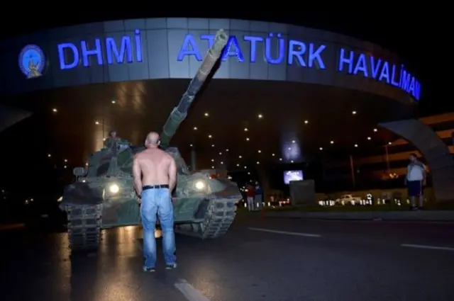 Man standing in front of a tank