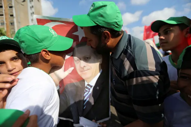 Hamas supporters in Gaza kiss picture of President Erdogan