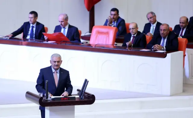 Turkish Prime Minister Binali Yildirim (front) addresses lawmakers at an extraordinary assembly at Turkish Parliament, in Ankara, Turkey