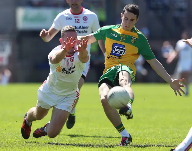 Tyrone's Niall Sludden tackles Donegal's Eoin McHugh