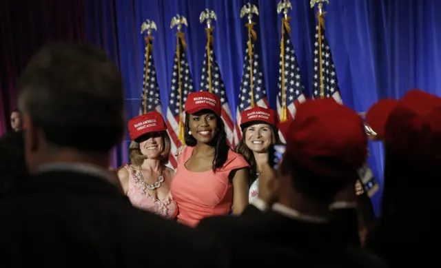 Theresa "Omarosa" Manigault poses with other Trump supporters.