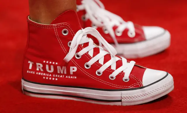 A delegate wears Trump sneakers at the start of the first day of the 2016 Republican National Convention.