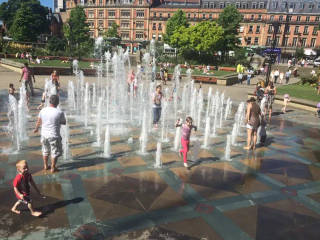 Children play in water in Peace Gardens