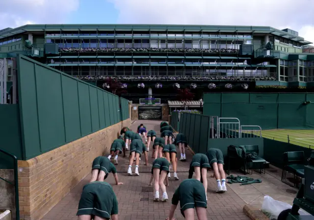 Wimbledon ball boy and girls exercise ahead of day six