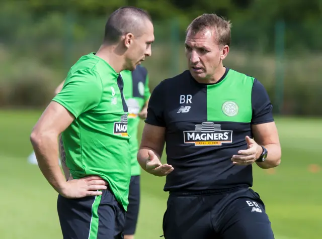 Brendan Rodgers in conversation with captain Scott Brown