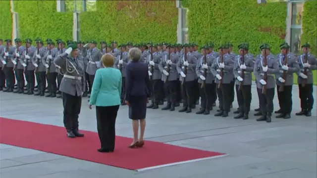 German troops greeted the UK PM with a guard of honour as she met her counterpart at the chancellery.