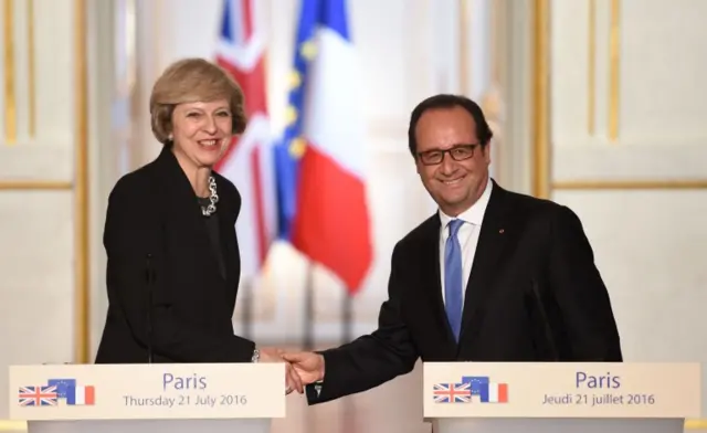 Theresa May and Francois Hollande shake hands