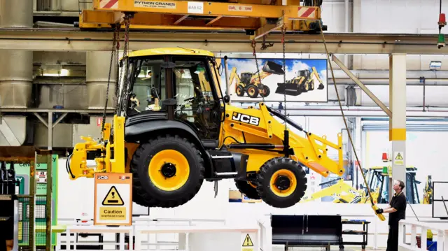 A JCB backhoe loader on its UK production line