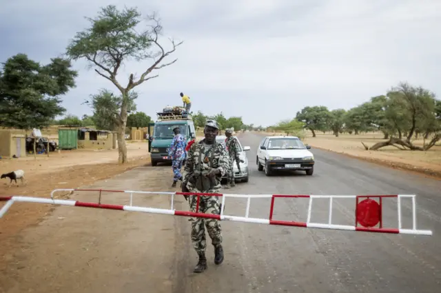 Malian soldiers control motorists at a checkpoint