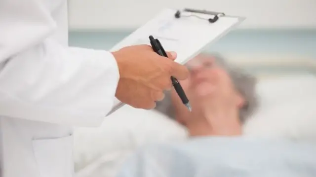 Hospital doctor with clipboard