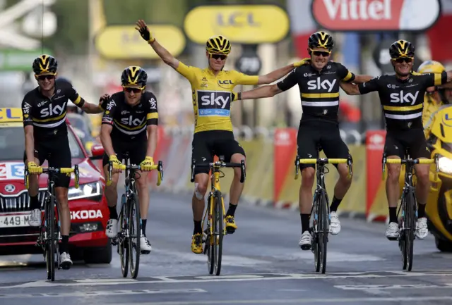 Chris Froome links arms with his Team Sky teammates