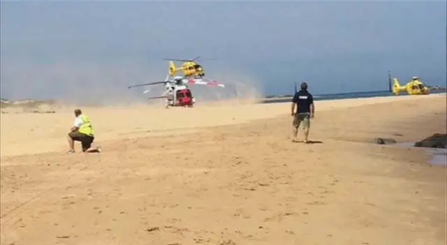 Three ambulances and rescue teams on Sea Palling beach