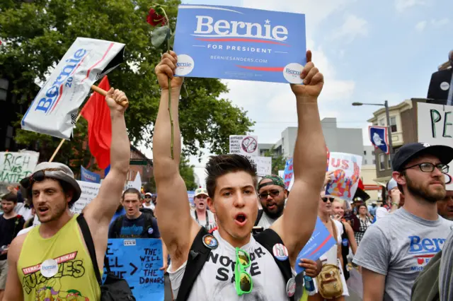 Bernie Sanders supporters march through downtown on the first day of the Democratic National Convention