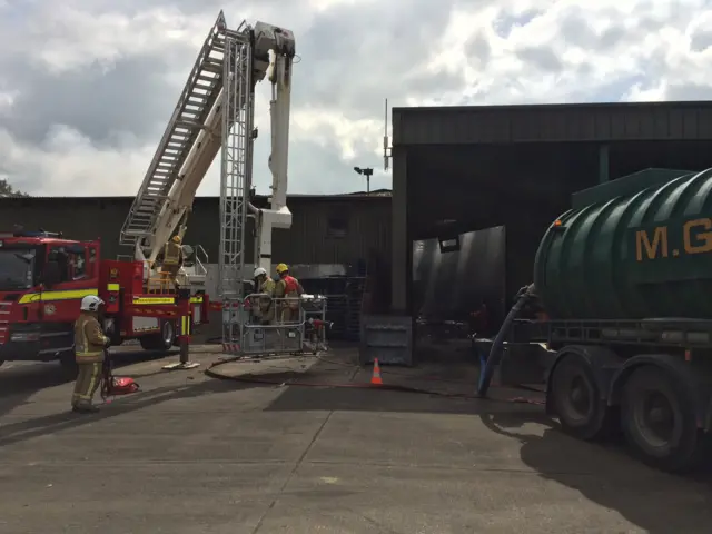 Fire crews and fire engine at the scene of the fire