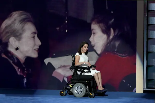 Anastasia Somoza, an international disability rights advocate, arrives on stage to deliver remarks on the first day of the Democratic National Convention.