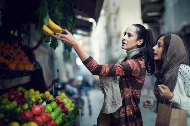 Two women shopping at a stall in Turkey.