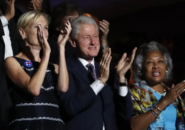 Former President Bill Clinton applauds Former Democratic presidential candidate Bernie Sanders at the Democratic National Convention.