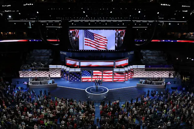 A flag flies on a jumbotron at the Democratic convention