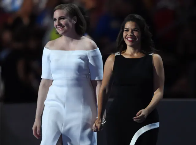 Actresses America Fererra (R) and Lena Dunham (L) walk onto the stage during the second day of the Democratic National Convention.