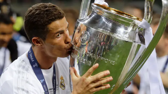 Real Madrid"s Cristiano Ronaldo kisses the trophy after the Champions League final soccer match