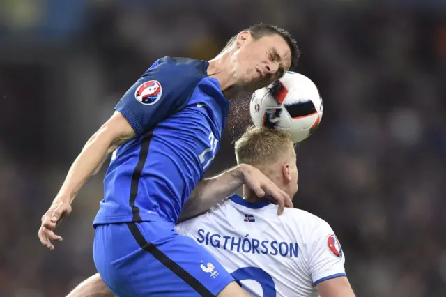 Laurent Koscielny beats Kolbeinn Sigthorsson to a header