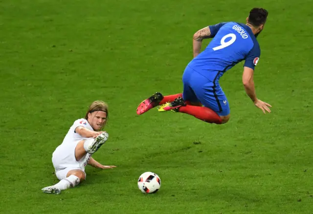 Birkir Bjarnason fouls Olivier Giroud