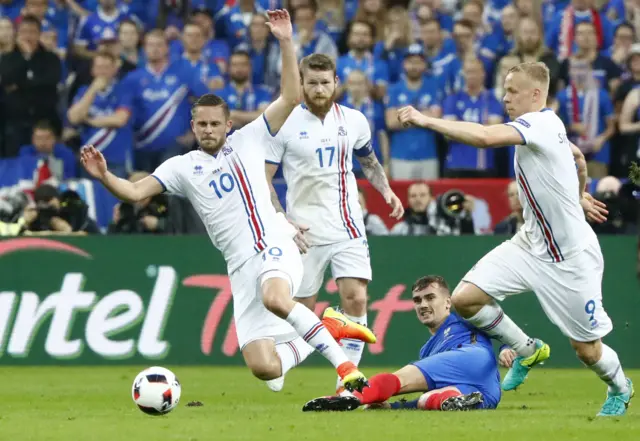 Gylfi Sigurdsson is fouled by Antoine Greizmann