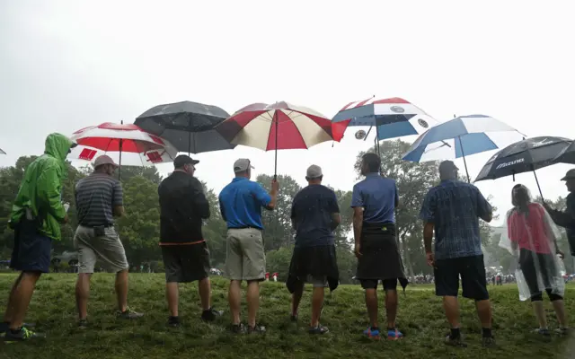 Fans with umbrellas