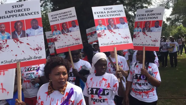 People holding banners protesting police killings in Kenya