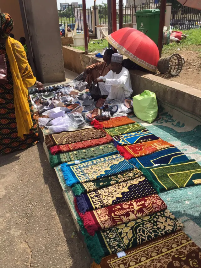 Market trader selling cloth and hats