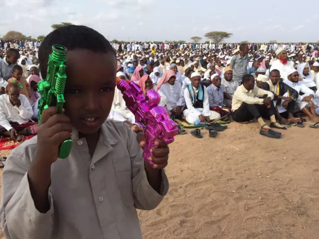 A boy with two water pistols