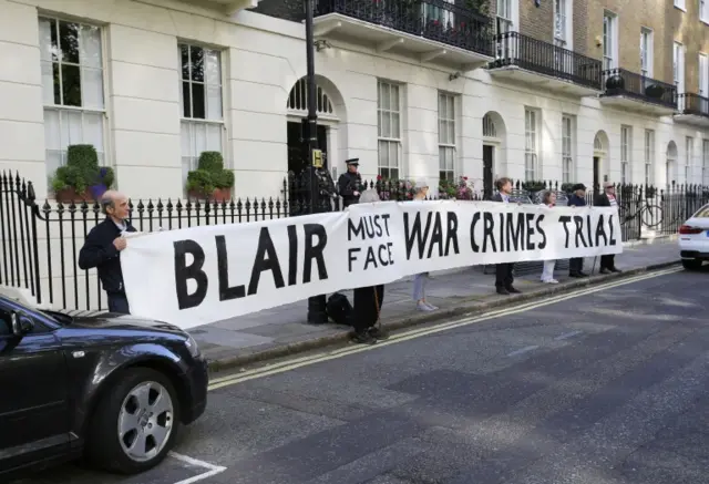 A banner is displayed by people opposed to the invasion of Iraq outside the home of Tony Blair