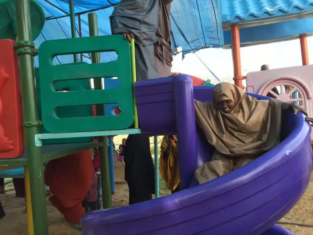 A girl on a slide in Garissa, Kenya