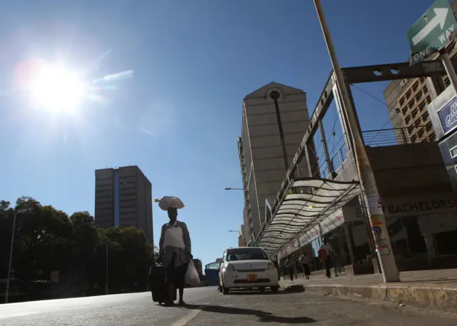 Woman walking on empty street in Harare, Zimbabwe