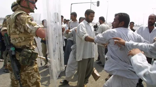 Iraqi civilians clashing with British soldiers in Basra, Iraq (August 2003)