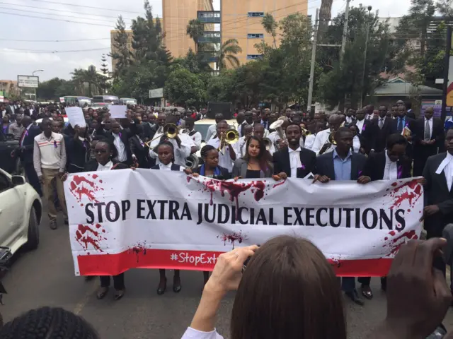 Protesters in Kenya holding up a sign saying: "Stop extra judicial executions"