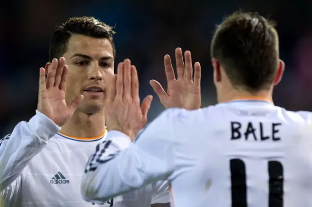 Cristiano Ronaldo (L) of Real Madrid CF clashes hands with his teammate Gareth Bale