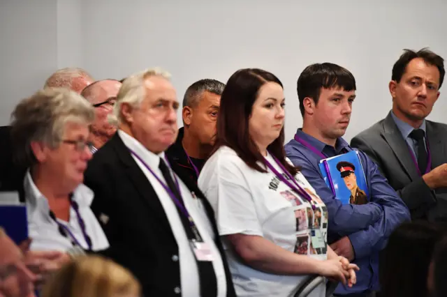 Families of some of the soldiers who died watch a news conference after Sir John Chilcot released his report