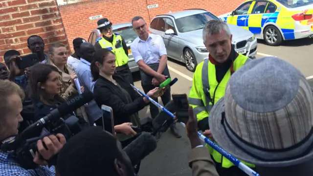 Fire service speaking to media and family members gathering outside Nechells