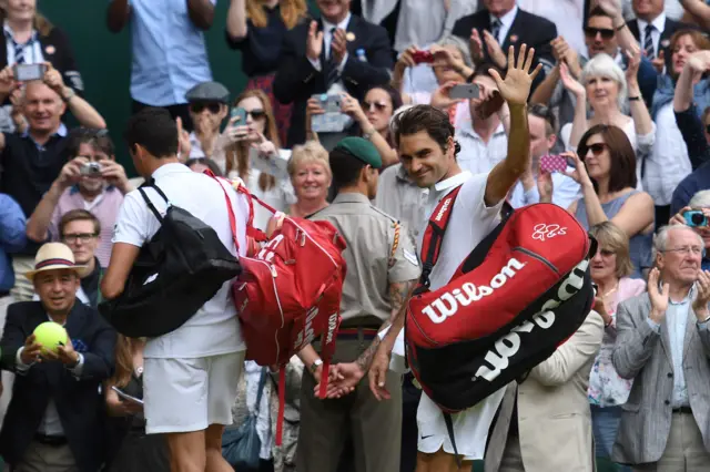 Roger Federer waves to the crowd